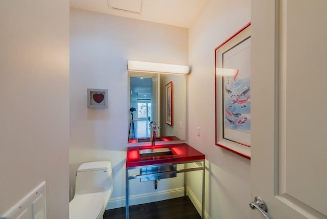 bathroom featuring hardwood / wood-style floors, toilet, and sink