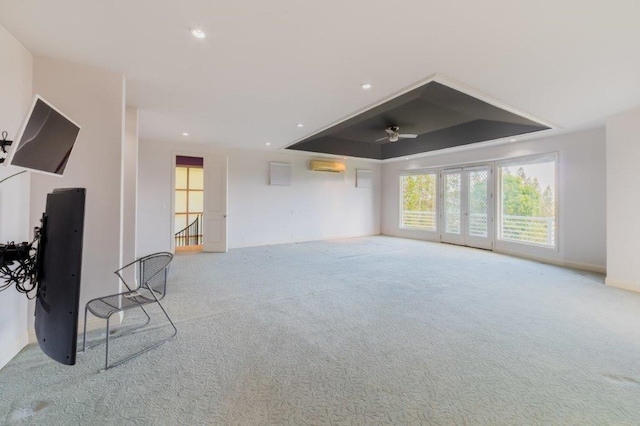 carpeted living room featuring ceiling fan and a raised ceiling