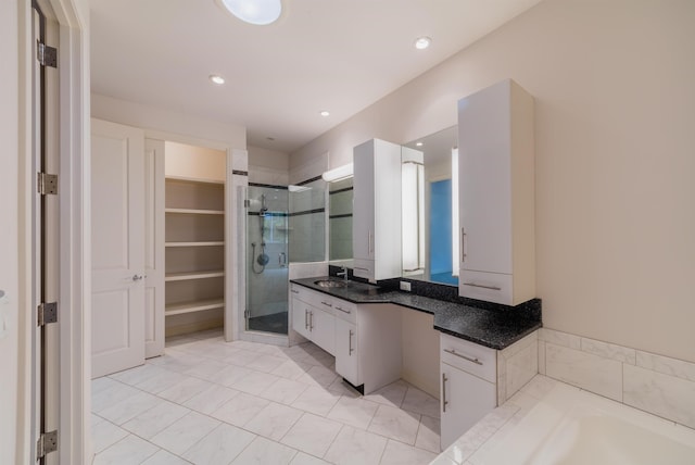 bathroom with separate shower and tub and vanity