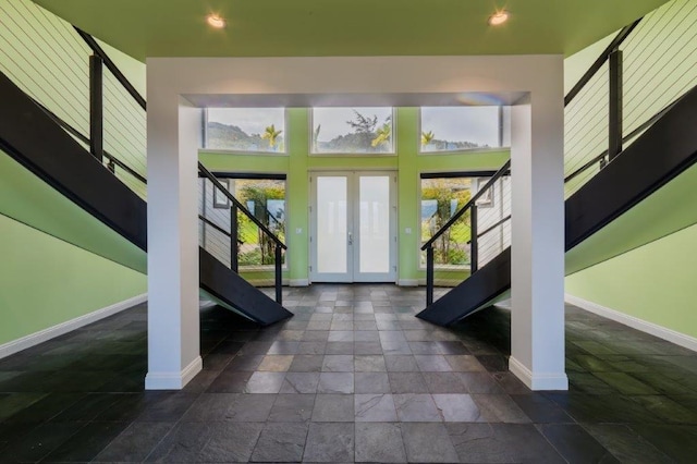 foyer entrance featuring french doors and a towering ceiling