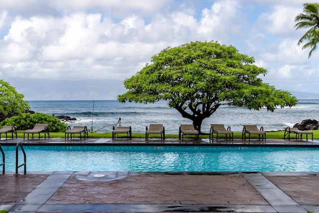 view of pool featuring a water view