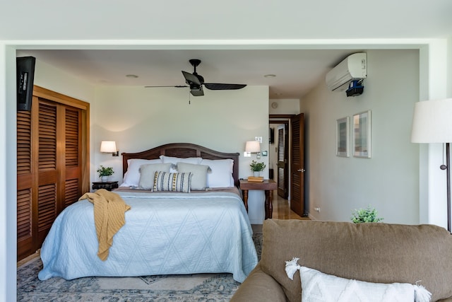 bedroom with ceiling fan, a closet, and a wall mounted AC