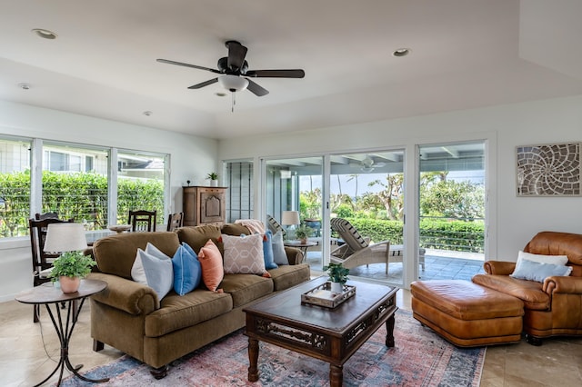 living room featuring ceiling fan and plenty of natural light