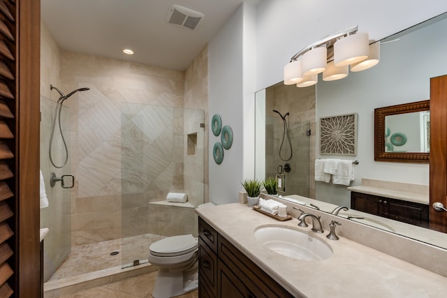 bathroom with toilet, vanity, tile patterned floors, and walk in shower