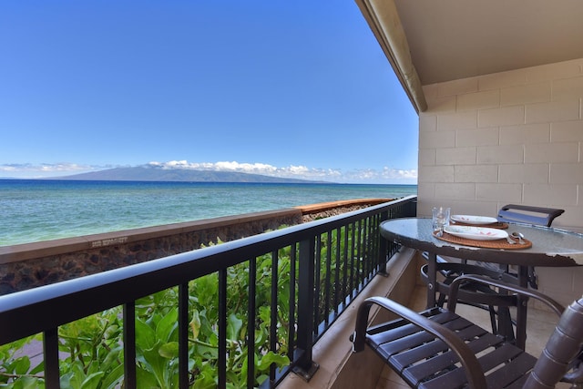 balcony featuring a water view and a view of the beach