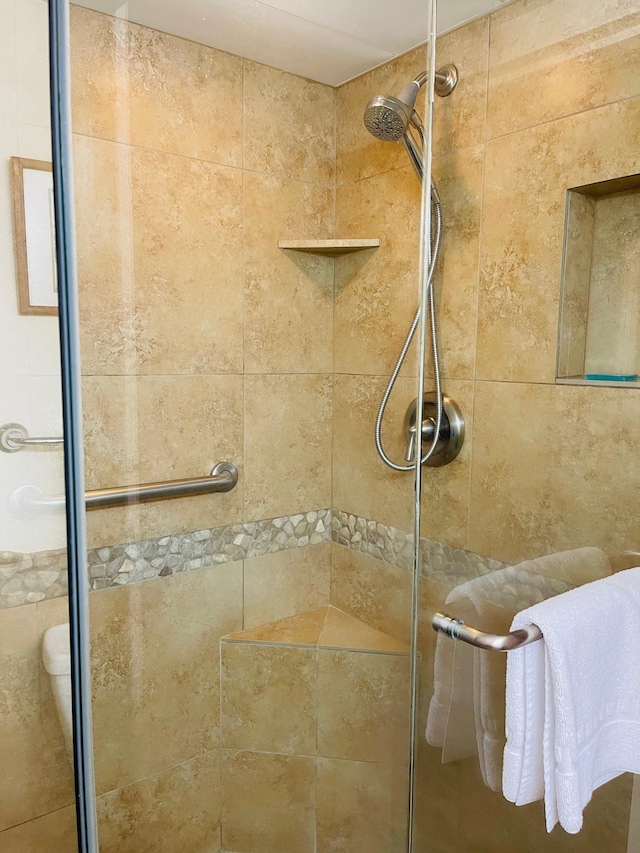 bathroom with tiled shower