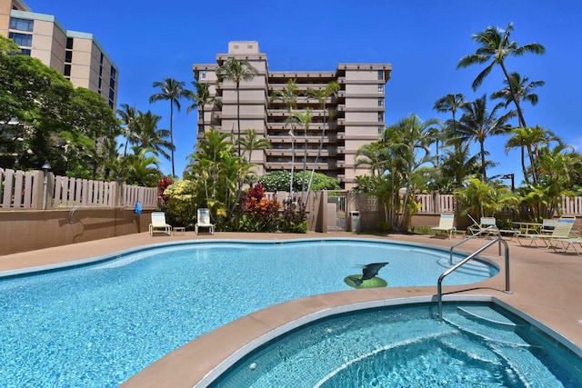 view of swimming pool featuring a community hot tub