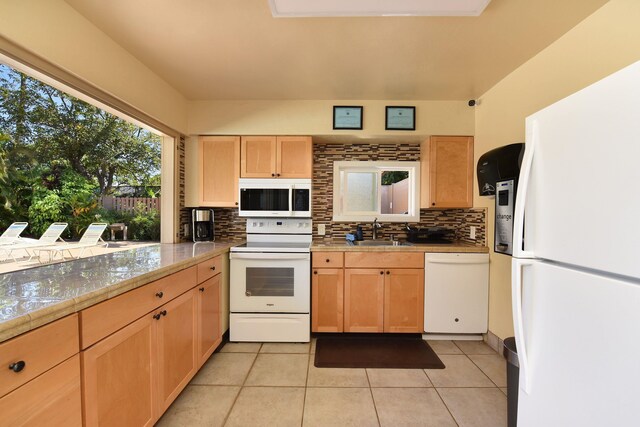 kitchen featuring light tile patterned floors, white appliances, backsplash, and sink