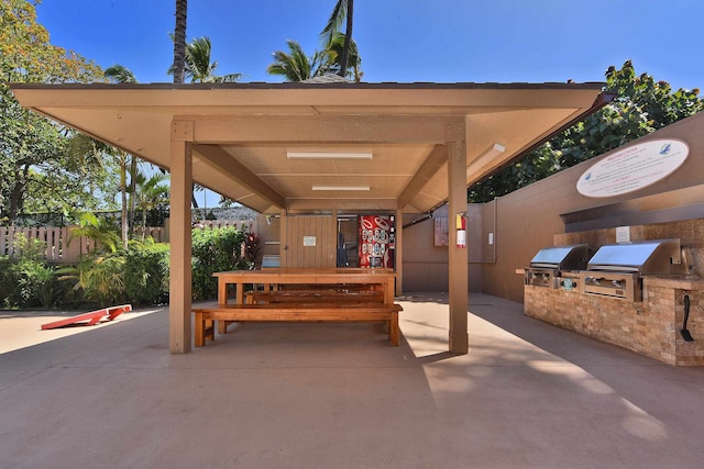 view of patio featuring a gazebo, grilling area, and exterior kitchen