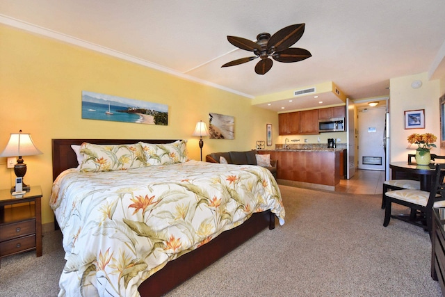 carpeted bedroom with ceiling fan, sink, and ornamental molding