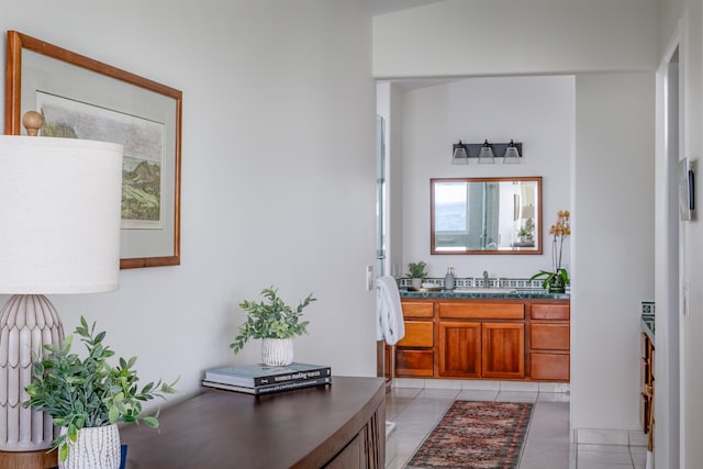 bathroom with tile patterned flooring, vanity, and lofted ceiling