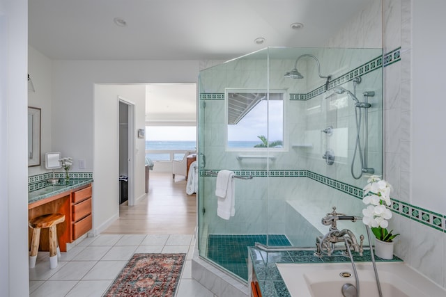 bathroom featuring tile patterned floors, vanity, and independent shower and bath