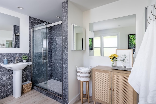 bathroom featuring hardwood / wood-style flooring and a shower with shower door