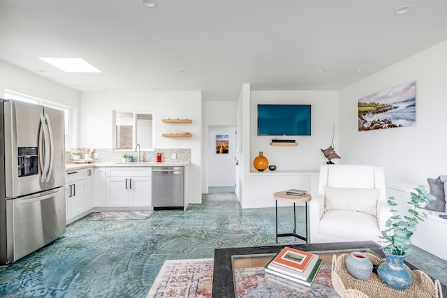 living room with a skylight and sink