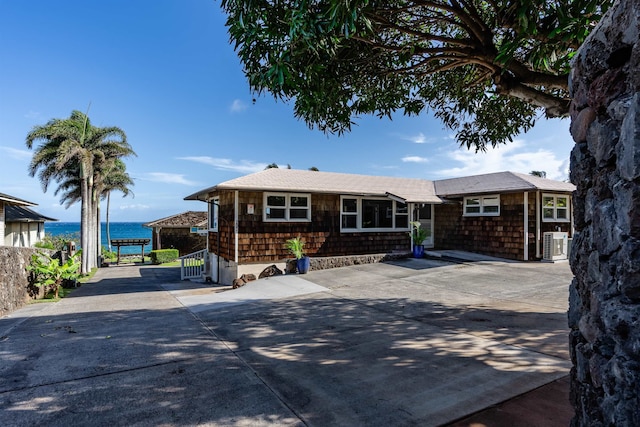 ranch-style home with cooling unit and a water view