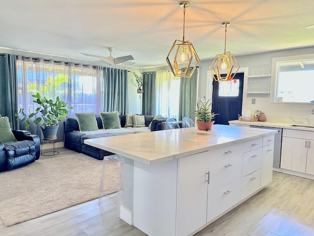 550 Kailana St, Wailuku, HI 96793 - kitchen featuring open floor plan, light wood-style flooring, and white cabinetry