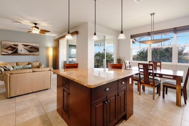 kitchen with ceiling fan, plenty of natural light, open floor plan, and visible vents