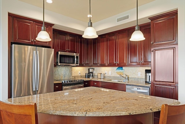 kitchen featuring decorative backsplash, visible vents, a sink, reddish brown cabinets, and stainless steel appliances