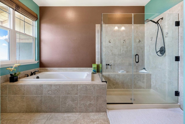 bathroom featuring tile patterned flooring, a bath, and a shower stall