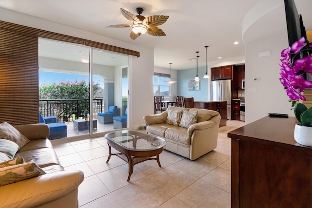 living room featuring light tile patterned floors, ceiling fan, and recessed lighting