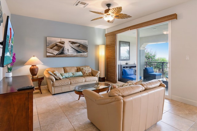 living area with visible vents, a ceiling fan, baseboards, and light tile patterned floors