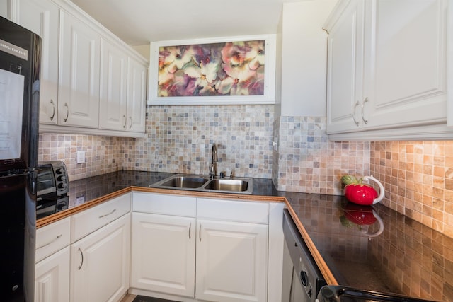 kitchen with range, white cabinetry, sink, dishwashing machine, and backsplash