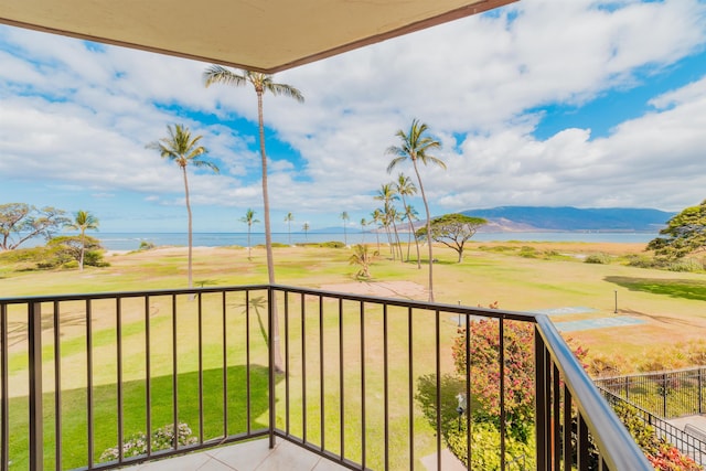 balcony featuring a water and mountain view