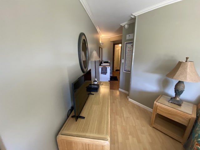 hall featuring ornamental molding and light hardwood / wood-style floors