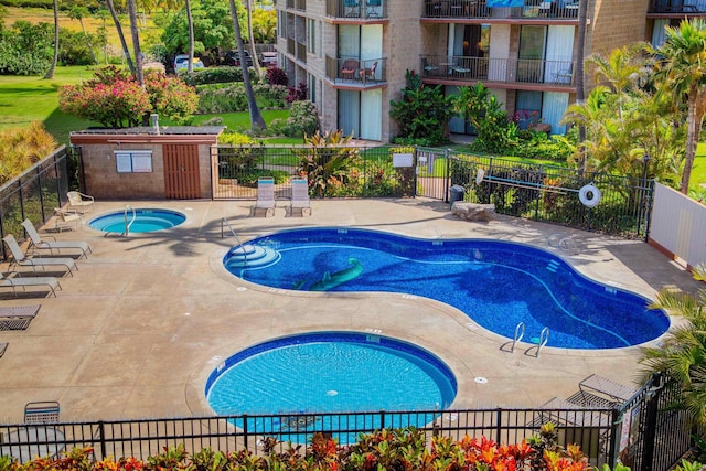 view of pool featuring a patio area and a community hot tub