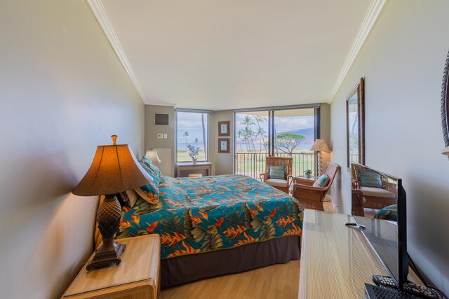 bedroom with access to outside, wood-type flooring, expansive windows, and crown molding