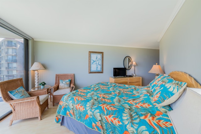 bedroom featuring a wall of windows and ornamental molding