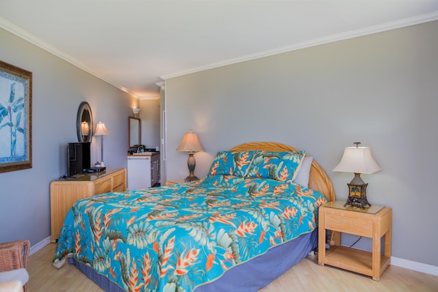 bedroom featuring crown molding and light hardwood / wood-style floors