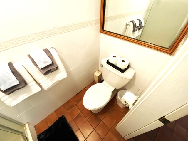 bathroom featuring toilet and tile patterned flooring