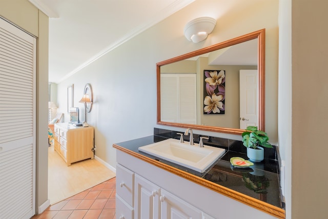 bathroom featuring vanity, tile patterned floors, and ornamental molding