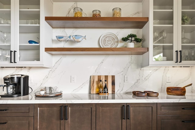 kitchen with dark brown cabinetry and tasteful backsplash