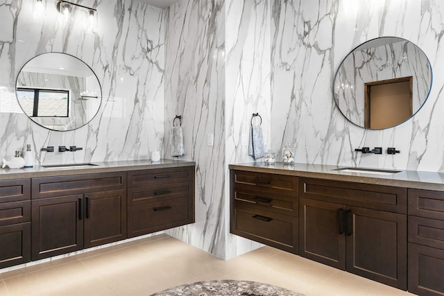 bathroom with tile patterned floors, vanity, and tile walls