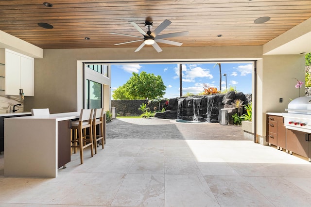 view of patio / terrace with grilling area, ceiling fan, and an outdoor bar