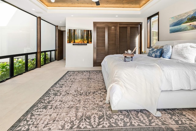 bedroom with a raised ceiling, a closet, and wood ceiling