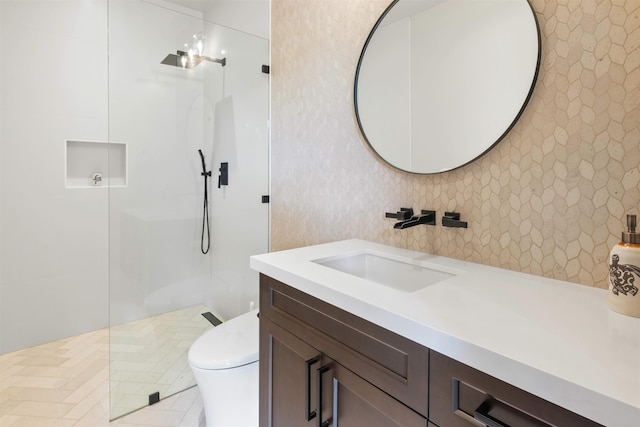 bathroom featuring walk in shower, vanity, and toilet