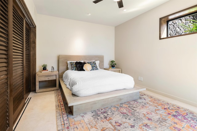 bedroom with ceiling fan, a closet, and light carpet