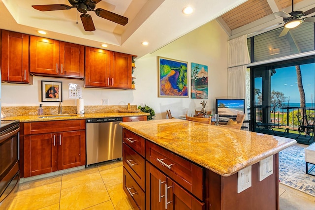 kitchen with light stone countertops, sink, ceiling fan, light tile patterned floors, and appliances with stainless steel finishes