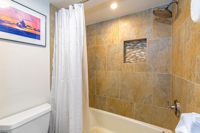 bathroom with shower / bath combination with curtain and toilet