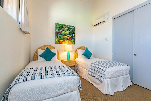 bedroom with a closet, carpet floors, and a wall mounted air conditioner