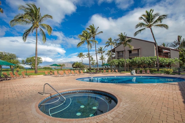 view of swimming pool featuring a patio area and a community hot tub