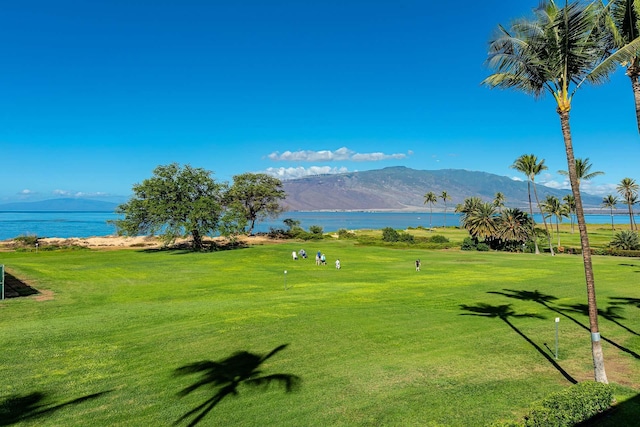 surrounding community featuring a lawn and a water and mountain view