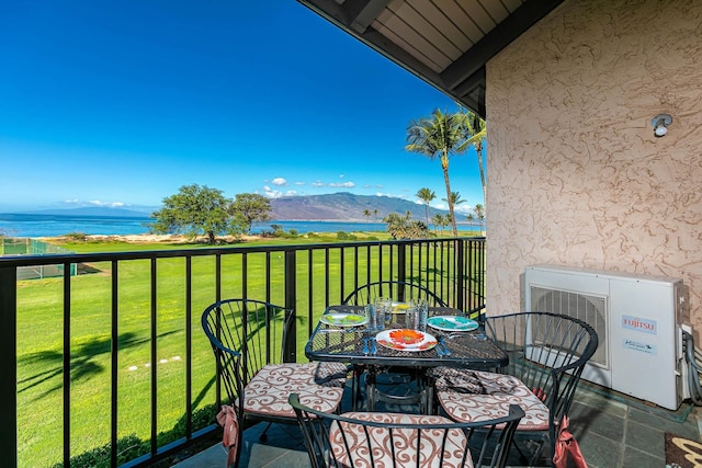 balcony featuring a water and mountain view and ac unit