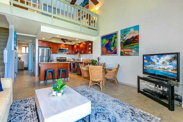 living room featuring a high ceiling and ceiling fan