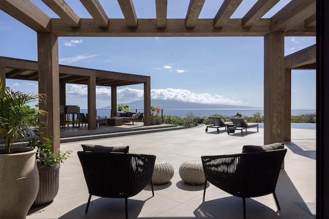 view of patio with an outdoor hangout area, a water view, and a pergola