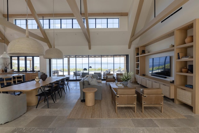 living room featuring beam ceiling, built in features, and a high ceiling