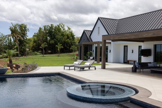 view of pool with a lawn, an in ground hot tub, and a patio